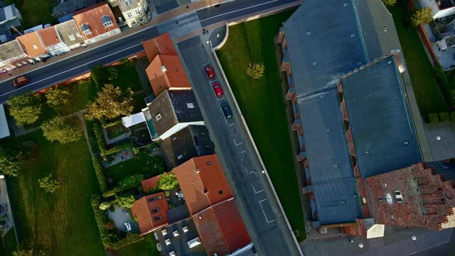 Top down view over a large medieval church made from red bricks. 4K aerial footage.