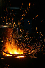 The sparks burning in the fire burned the water kettle