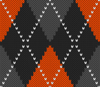 Knitted argyle Halloween pattern. Wool knitinng. Scottish plaid in orange, black and grey rhombuses. Traditional  Scottish background of diamonds . Seamless fabric texture. Vector illustration