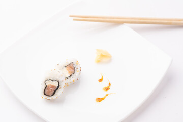 urakami style sushi roll on white plate and white background