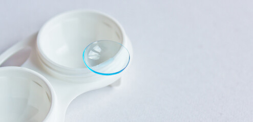 Soft contact lenses and white plastic case. Close up. Selective focus.