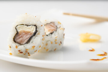 urakami style sushi roll on white plate and white background