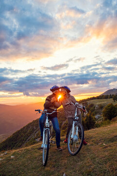 elderly couple with bicycles standing at the mountain park kissing © FS-Stock