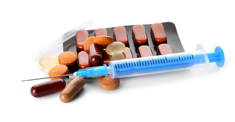 Pills and syringe on white background