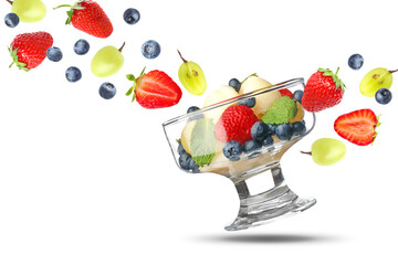 Delicious fruit salad in bowl and flying ingredients on white background
