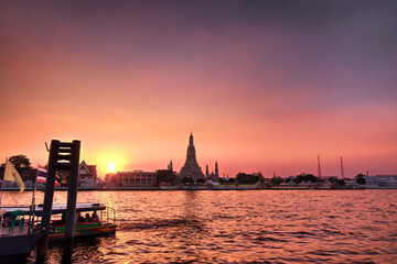 Naklejka premium Chao Phraya River with temple of dawn Wat Arun in background. Bangkok Thailand