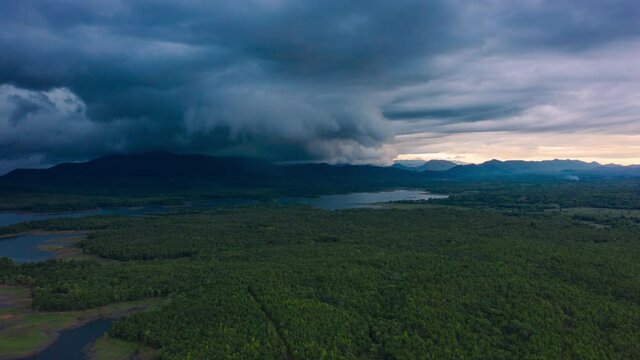 Hyper lapse video 4K, Arcus cloud or shelf cloud, Rain storms and black clouds moving over the mountains in dam the north of Thailand, Mae Mo district, Lampang.