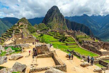 Tourists visiting the Inca ruin and lost city of Machu Picchu, Cusco, Peru.