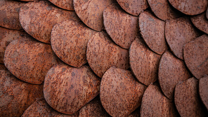 Close up textured background of rusted metal fish scale shapes - horizontal format
