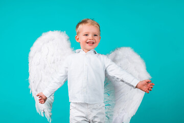 Kids with angel wings. Little cute boy child in angel dress with happy smiling face. Cupid valentin...