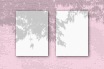 3 vertical sheets of textured white paper on soft pink table background. Mockup overlay with the plant shadows. Natural light casts shadows from an branch of Apple . Horizontal orientation