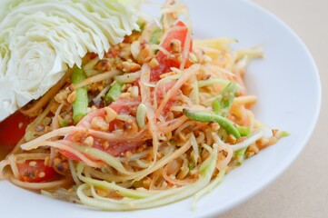 spicy papaya salad on wood floor - Thailand healthy food