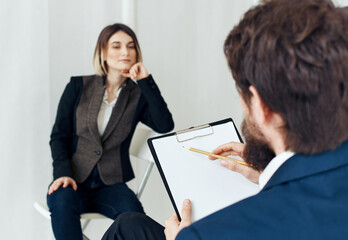 A man communicates with a woman and documents are in the hands of a psychologist at a doctor's appointment