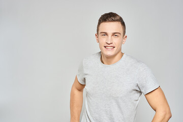 handsome man in light t-shirt cropped view emotion studio isolated background