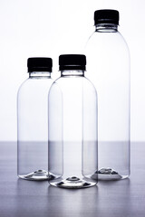 Bottles of water on black table white background