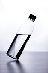 Bottle of water on black table white background