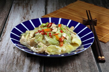 Fried and stirred instant rice noodle with gravy sauce and mixed vegetable. Famous traditional vegetarian menu in  Asia restaurant. Low fat and diet food.