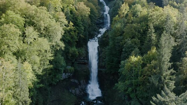 Flying Towards The Majestic Giessbach Waterfall In Brienz, Switzerland During Autumn - aerial drone