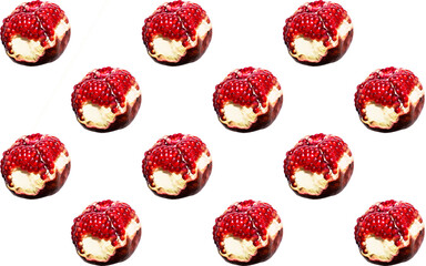 a pattern of juicy and ripe pomegranate fruit on a white background. this exotic fruit contains many vitamins and minerals