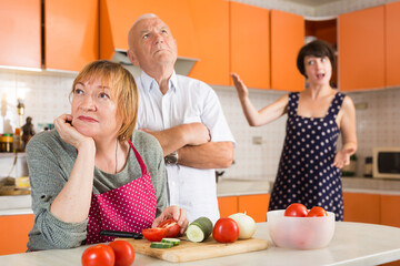 Senior woman offended her family sitting in kitchen