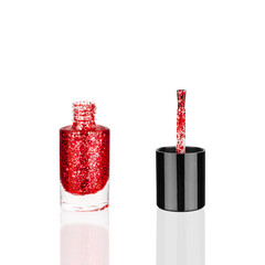 Red glittering nail polish glass bottle & brush white background isolated close up, open pink sequin varnish, bright shiny scarlet lacquer, sparkling enamel, beautiful shimmer gel, cosmetic accessory