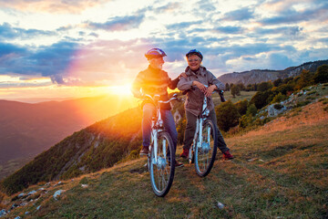 Naklejka premium Active Senior Couple Riding Bikes In Park