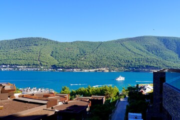 Fototapeta na wymiar Beautiful panoramic landscape on the emerald bay of the Aegean Sea with green hills, eucalyptus, snow-white yachts. Luxury relax tourism conception, Lujo hotel Bodrum