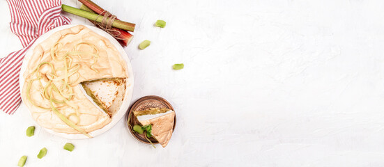 Traditional Swedish cuisine. homemade rhubarb cake with meringue on top, light background, top view banner menu recipe place for text