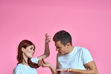 enamored man and woman hugging each other on a pink background cropped with Copy Space family portrait