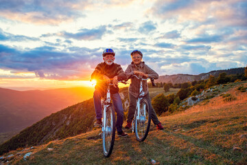 Fototapeta na wymiar Active Senior Couple Riding Bikes In Park