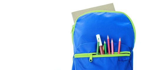 School supplies for school children In a blue backpack on a white background.