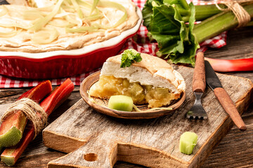 Traditional Swedish cuisine. homemade rhubarb cake with meringue on top, on a wooden background, Food recipe background. Close up