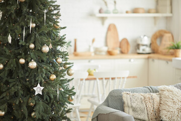 Image of Christmas tree decorating with beautiful toys and balls in the room