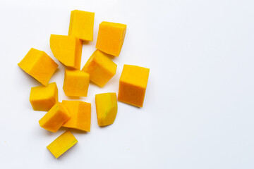 Cut and slices butternut squash on white background.