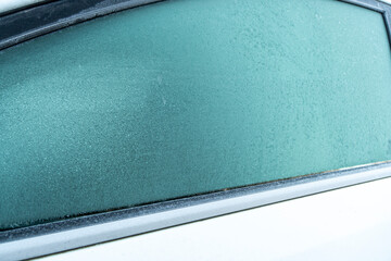  Frozen glass of the car. The patterns on the side car glass. Winter texture background. Frozen window of the car.