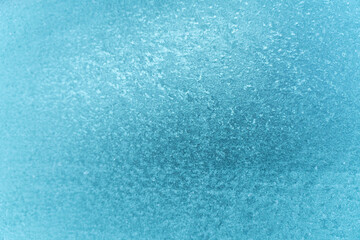 Frozen glass of the car. The patterns on the side car glass. Winter texture background. Frozen window of the car.