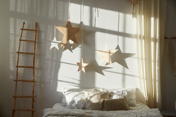 Image of modern bedroom with bed and decoration in the shape of stars