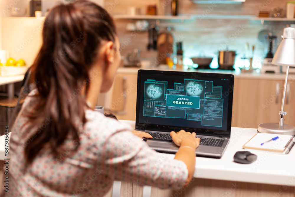 Poster hacker woman launching a cyberattack on bank firewall from home during night time. programmer writin