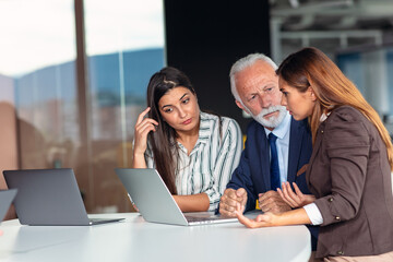 Group of business persons in discussion. Working together.