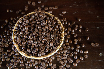 Hot roasted coffee beans piled in baskets on the wooden floor.