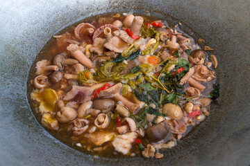 Mushroom curry with tamarind leaves and betel leaves, local food.
