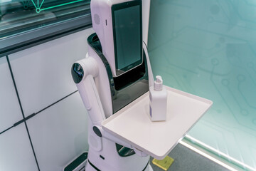robot holding sanitizer for customer during covid 19 pandemic.