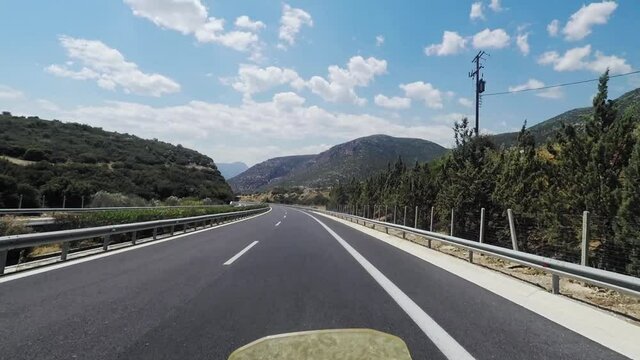 Helmet camera view of motorcycle travelling on empty highway. Peloponnese highway Moreas, summer of 2020