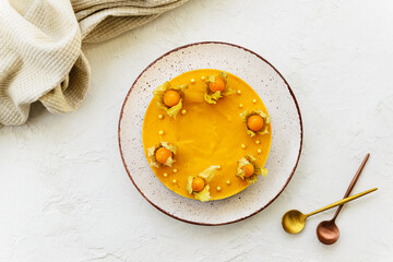 Pumpkin pie decorated with physalis on the table. Horizontal orientation, top view.