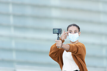 Social media content creation during Coronavirus pandemic concept. A young woman recordin handheld a make up tutorial.