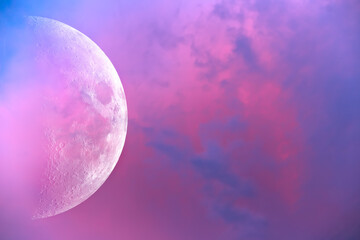 The big moon against the backdrop of beautiful sunset clouds.