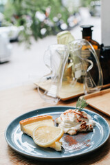  Lemon tart with whipping cream, sliced on a white plate.Delicious, appetizing, homemade dessert. Traditional french sweet pastry tart.