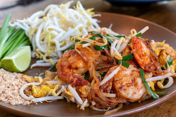 Pad Thai, Traditional stir-fried rice noodle dish commonly served as a street food and at most restaurants in Thailand as part of the country's cuisine. Stir fry noodles with sweet savoury sour sauce.