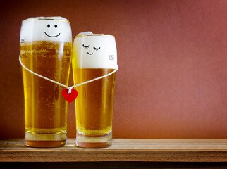 Two glasses of beer with Painted happy couple and red heart on bar counter.