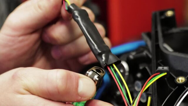 Electric bicycle repair. Installing heat shrink tubing on wires with a lighter